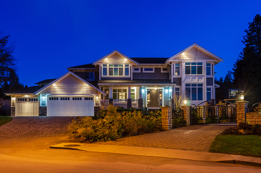 Luxury house at night with landscape lighting.