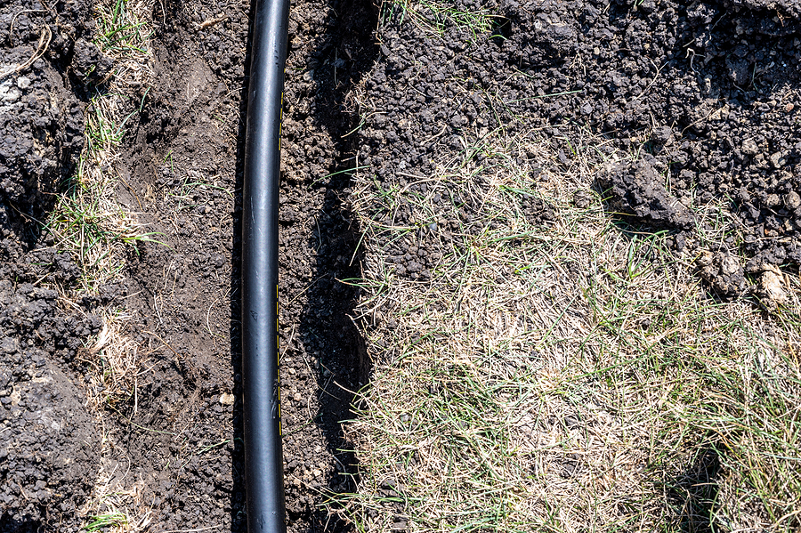 Shallow trench dug with water line running through it